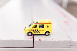 Toy ambulance sitting on a white table representing personal injury claims in Northern Ireland